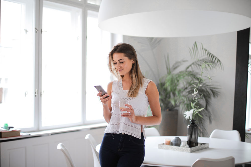 Girl typing on a digital diary app at home.