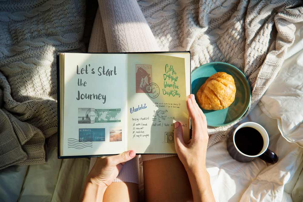 Woman reading note diary on bed breakfast morning.